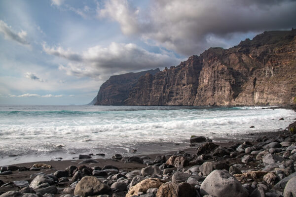 View to Atlantic ocean and Los Gigantes cliffs from  volcanic black sand beach Playa de los Guios, Tenerife, Canary island, Spain